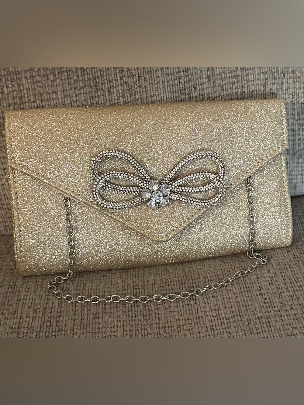 Used once. Gold Glitter Bow Chain Clutch